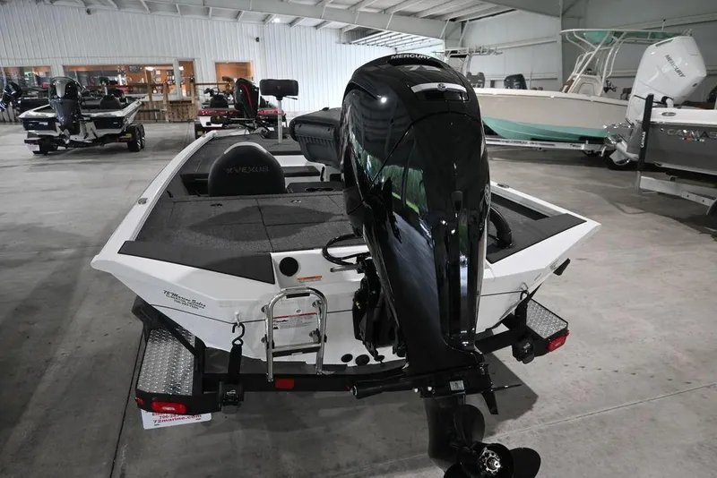 Slide: The Image of 2026 Vexus AVX181 DEFENDER boat with Mercury outboard motor in showroom. - 3