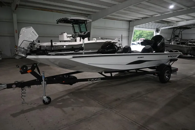 Slide: The Image of 2026 Vexus AVX181 DEFENDER boat on trailer in indoor storage facility. - 6