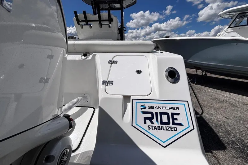 Slide: The Image of 2026 Tidewater 272 LXF boat with Seakeeper Ride stabilization system, under a blue sky. - 13