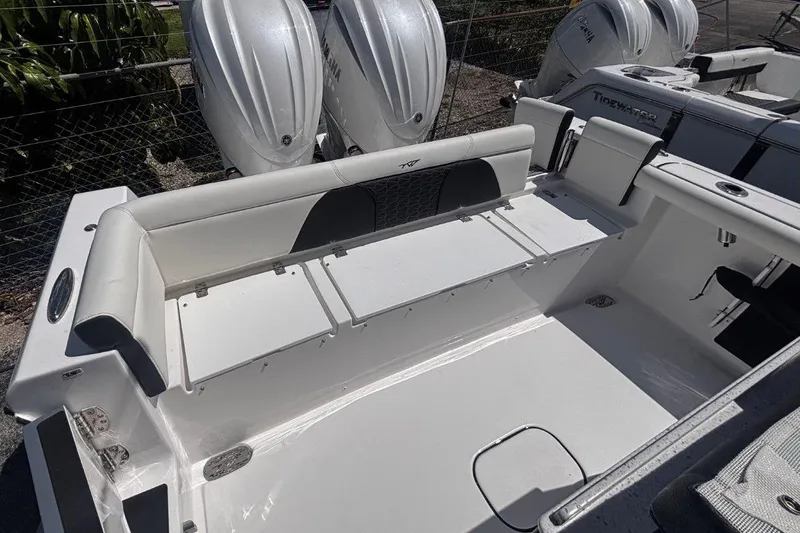 Slide: The Image of 2026 Tidewater 272 LXF boat interior with seating and dual outboard engines. - 17