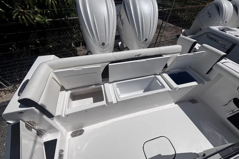 Slide: The Image of 2026 Tidewater 272 LXF boat with open storage compartments and dual outboard engines. - 18