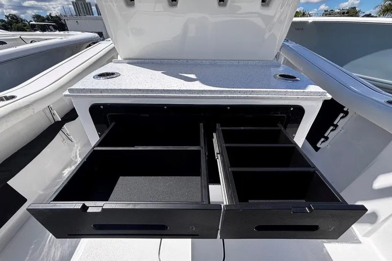 Slide: The Image of 2026 Tidewater 272 LXF boat storage compartments with open drawers, showcasing ample space. - 23