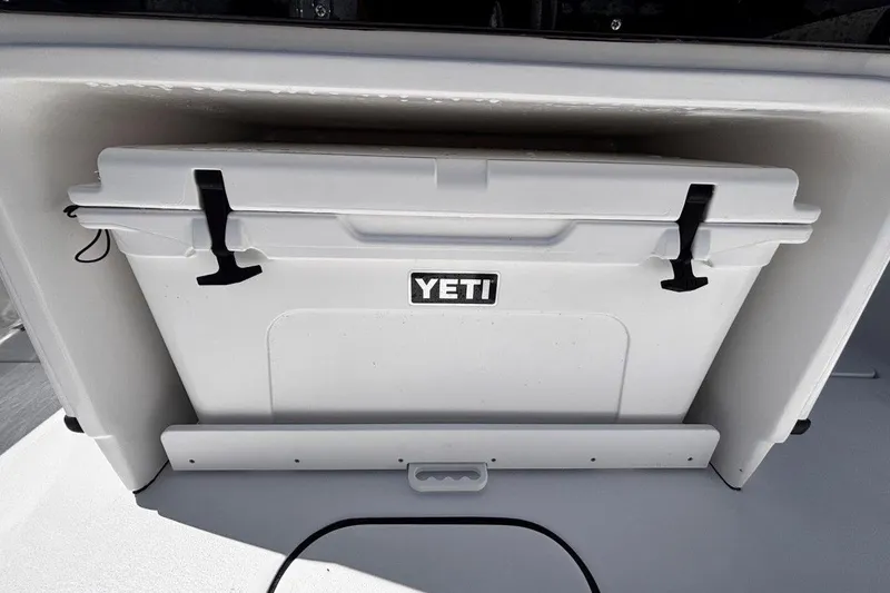 Slide: The Image of YETI cooler on 2026 Tidewater 272 LXF boat, securely stored in compartment. - 24