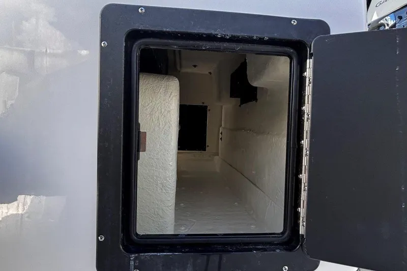 Slide: The Image of Open storage compartment on 2026 Tidewater 272 LXF boat, showcasing interior space. - 25