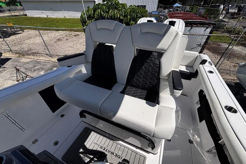 Slide: The Image of 2026 Tidewater 272 LXF boat with dual white and black cushioned seats. - 26