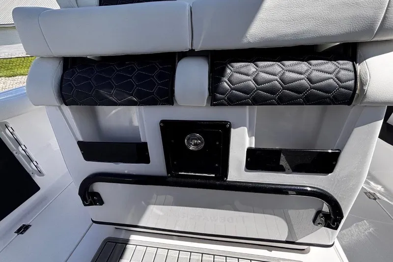 Slide: The Image of 2026 Tidewater 272 LXF boat interior with cushioned seating and sleek design. - 27