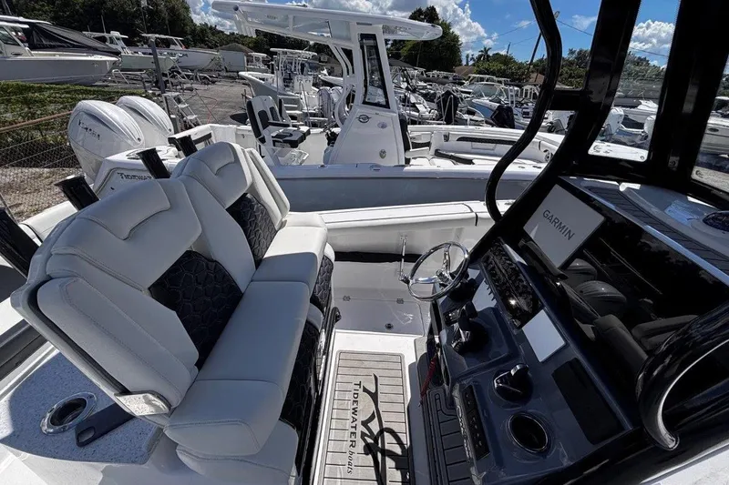 Slide: The Image of 2026 Tidewater 272 LXF boat interior with modern seating and Garmin navigation system. - 28