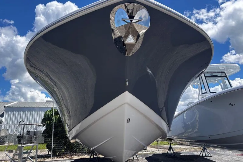 Slide: The Image of 2026 Tidewater 272 LXF boat, sleek design, displayed outdoors under a blue sky. - 3