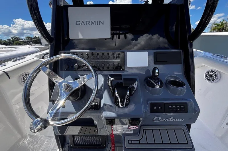 Slide: The Image of 2026 Tidewater 272 LXF boat dashboard with Garmin navigation system and steering wheel. - 32