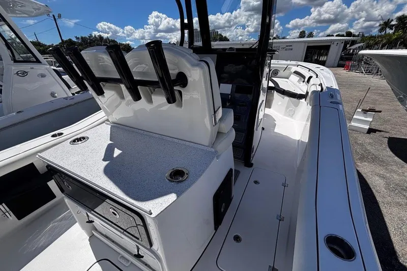 Slide: The Image of 2026 Tidewater 272 LXF boat interior with seating and rod holders under a sunny sky. - 37