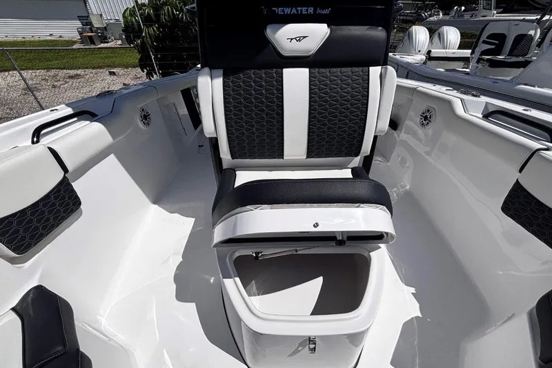 Slide: The Image of 2026 Tidewater 272 LXF boat interior with black and white seating and storage compartment. - 39