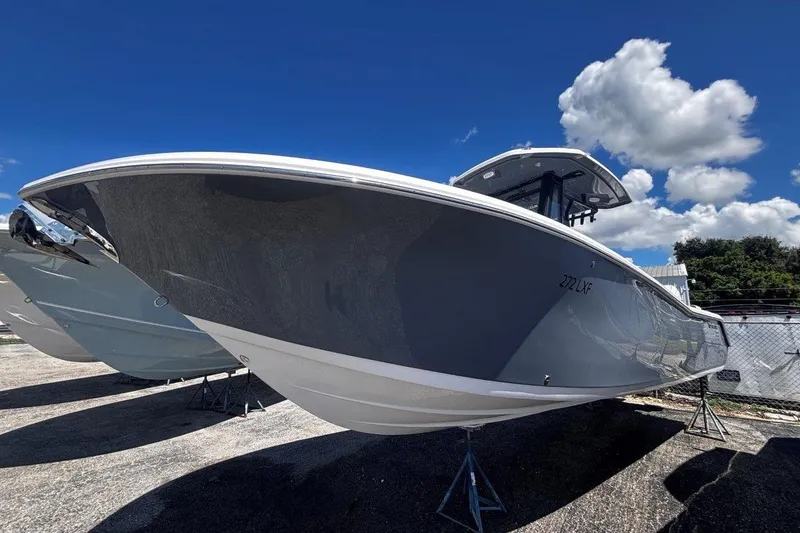Slide: The Image of 2026 Tidewater 272 LXF boat displayed outdoors under a clear blue sky. - 5