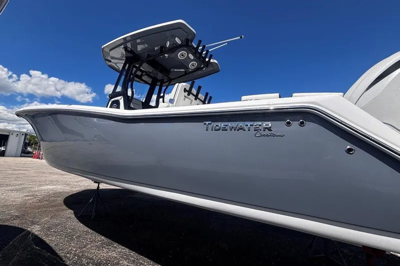 Slide: The Image of 2026 Tidewater 272 LXF boat with sleek design under clear blue sky. - 6