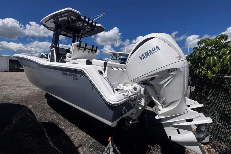 Slide: The Image of 2026 Tidewater 272 LXF boat with Yamaha engine, parked outdoors under a blue sky. - 7