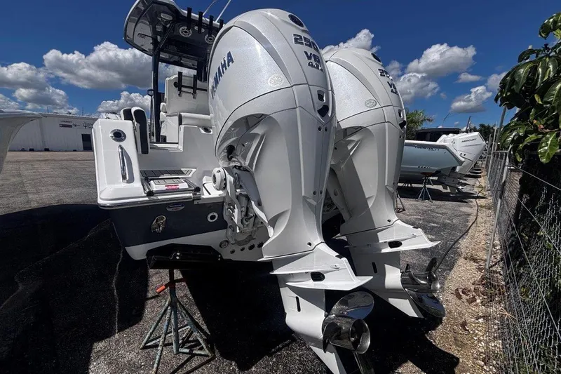 Slide: The Image of 2026 Tidewater 272 LXF boat with dual Yamaha outboard engines, parked outdoors. - 8