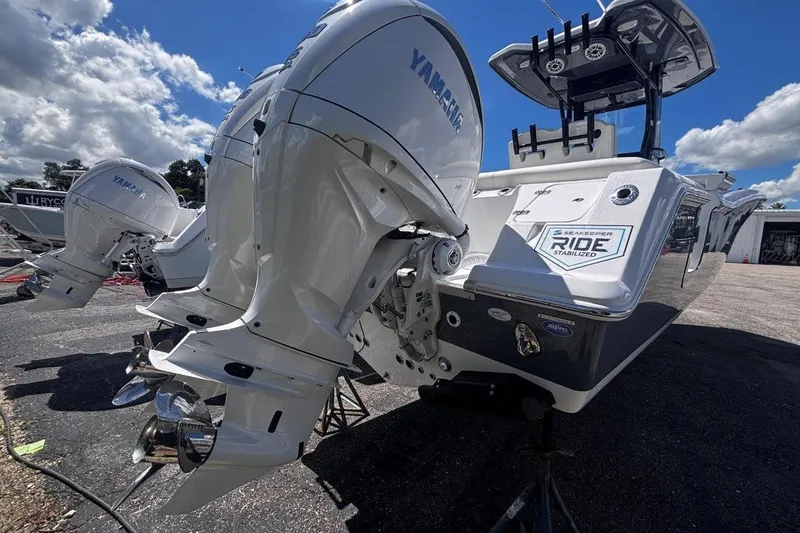 Slide: The Image of 2026 Tidewater 272 LXF boat with Yamaha engines, Seakeeper Ride Stabilized, under a blue sky. - 9