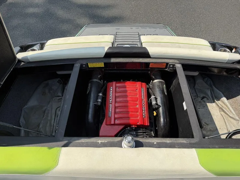 Slide: The Image of 2015 Malibu 22 VLX boat engine compartment with red Monsoon 350 engine. - 7