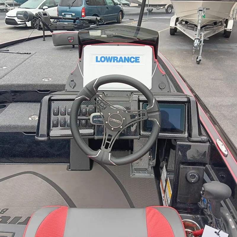 Slide: The Image of 2025 Triton 20XP boat dashboard with Lowrance electronics and steering wheel. - 13