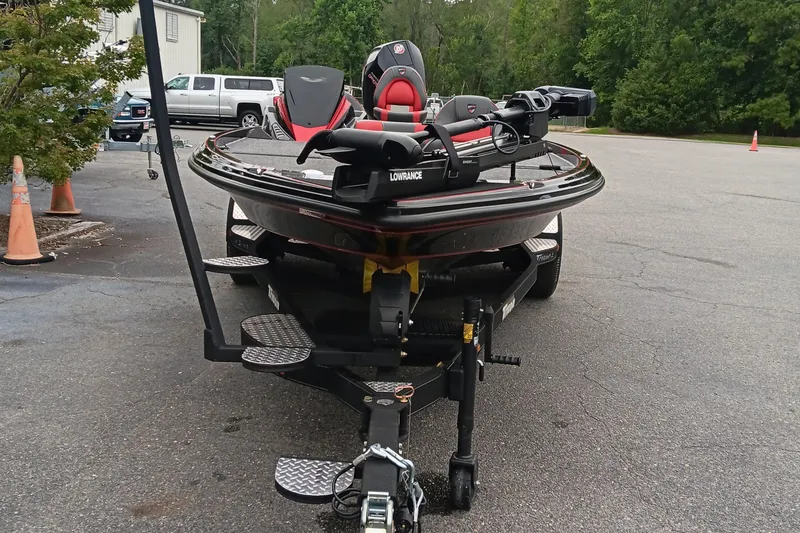 Slide: The Image of 2025 Triton 20XP boat on trailer in parking lot, featuring Lowrance equipment. - 7