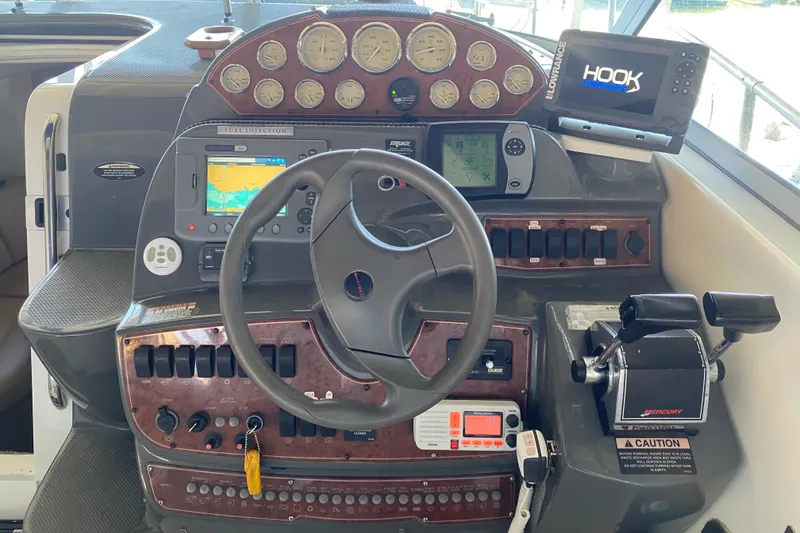 Slide: The Image of Dashboard of a 2005 Bayliner 325 boat with navigation instruments and controls. - 14