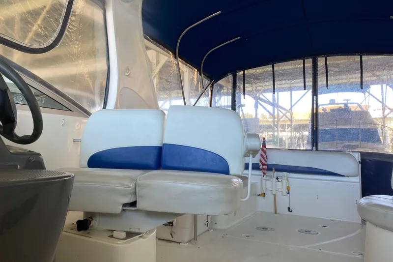 Slide: The Image of Interior of a 2005 Bayliner 325 boat with blue and white seating. - 15