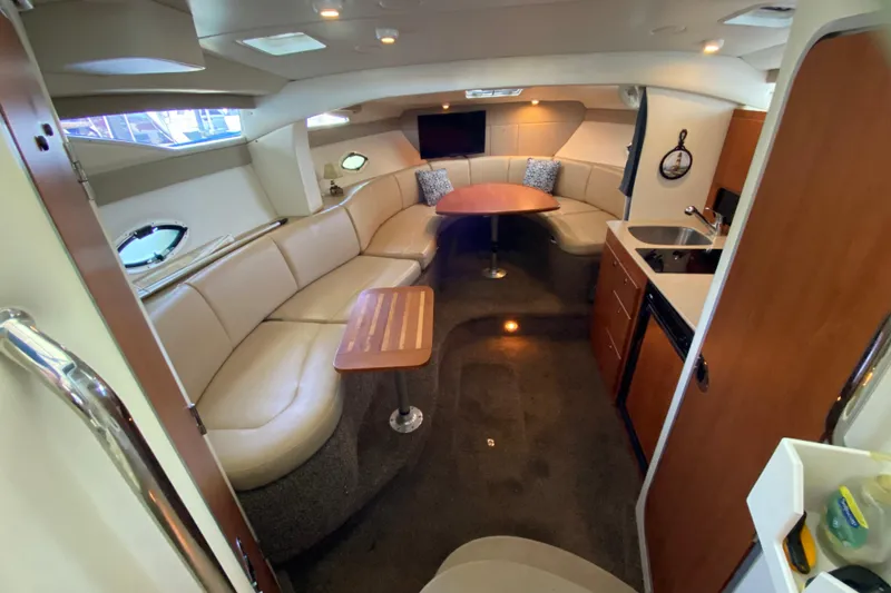 Slide: The Image of Interior of 2005 Bayliner 325 yacht with cozy seating, kitchenette, and modern amenities. - 16
