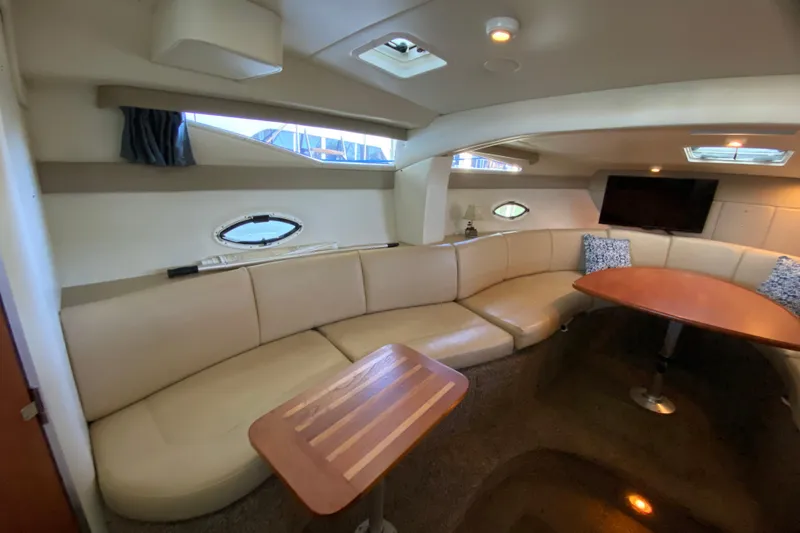 Slide: The Image of Luxurious interior of a 2005 Bayliner 325 yacht with plush seating and elegant table. - 17