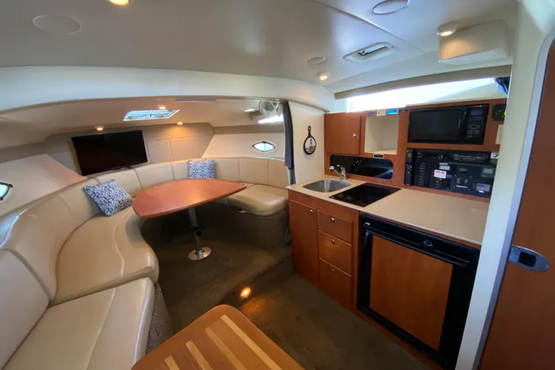 Slide: The Image of Luxurious 2005 Bayliner 325 yacht interior with kitchenette and cozy seating area. - 18