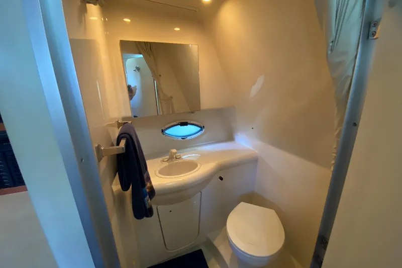 Slide: The Image of Bathroom interior of 2005 Bayliner 325 boat with sink, mirror, and toilet. - 19