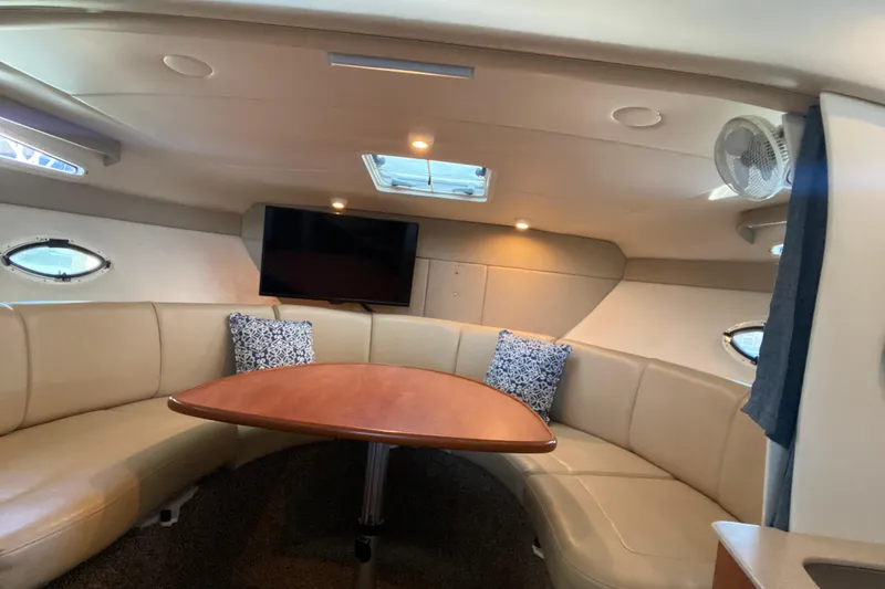 Slide: The Image of Interior of 2005 Bayliner 325 yacht with curved seating and mounted TV. - 22