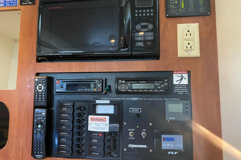 Slide: The Image of Control panel of a 2005 Bayliner 325 boat with microwave and electrical switches. - 24
