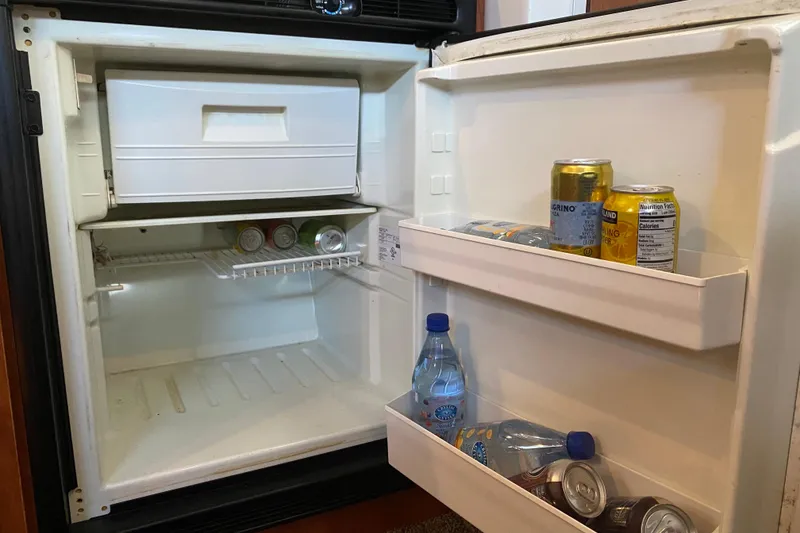 Slide: The Image of Open fridge in 2005 Bayliner 325 boat with drinks and water bottles. - 25