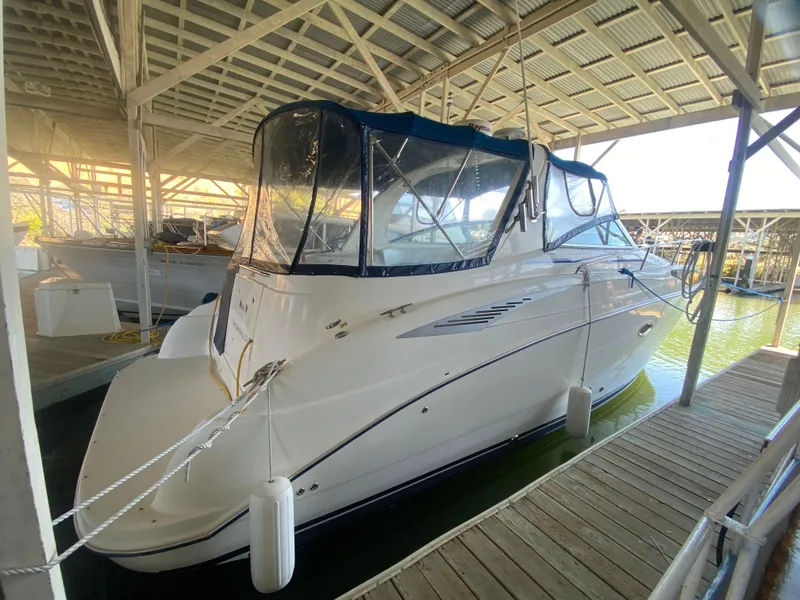 Slide: The Image of 2005 Bayliner 325 boat docked in a covered marina. - 4