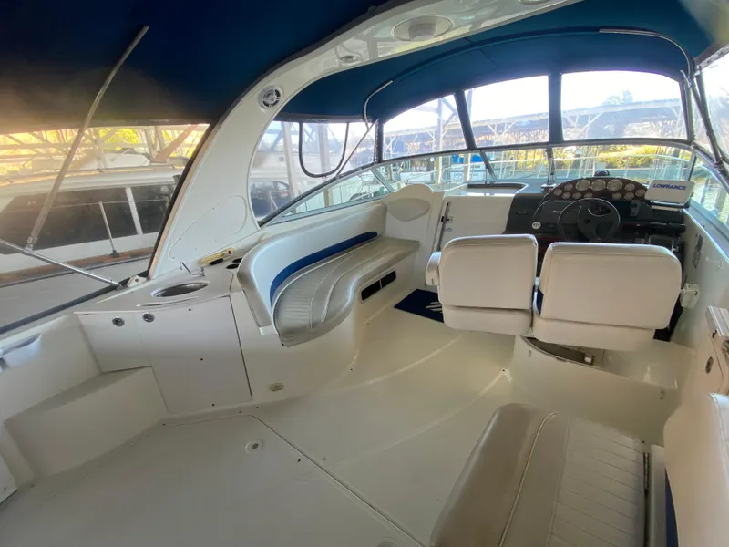 Slide: The Image of 2005 Bayliner 325 boat interior with white seating and control panel. - 6