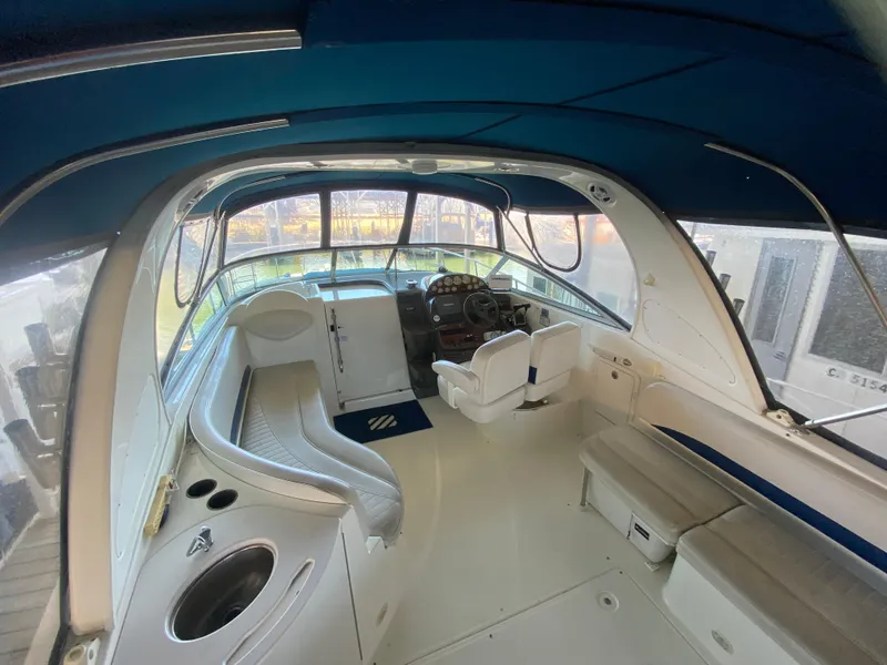 Slide: The Image of Interior of a 2005 Bayliner 325 boat with seating and helm. - 7