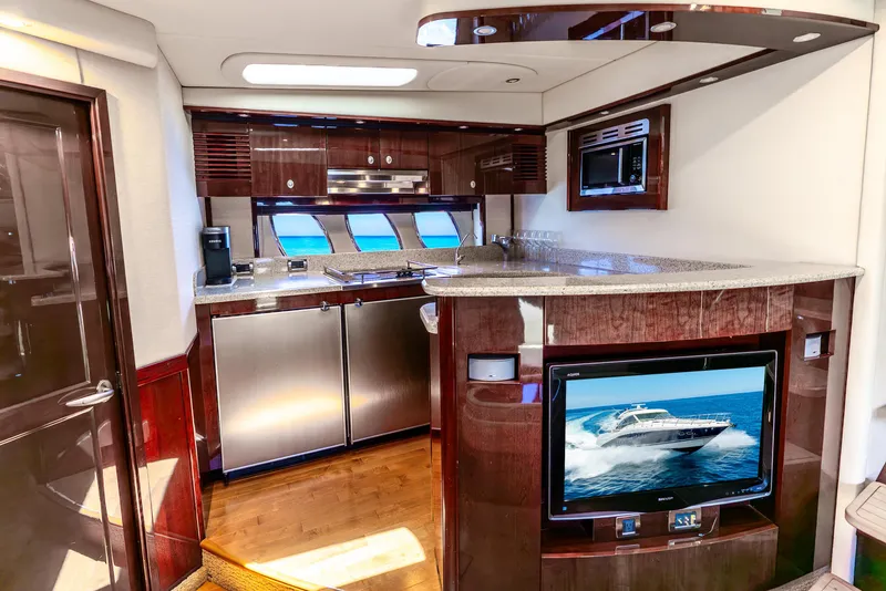 Slide: The Image of Luxurious 2008 Sea Ray 60 Sundancer yacht interior with modern kitchen and entertainment system. - 10