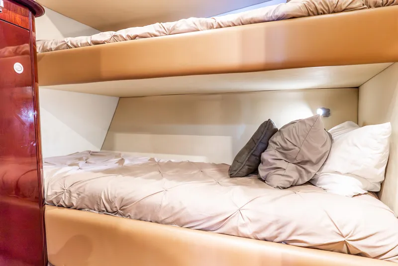 Slide: The Image of Bunk beds in 2008 Sea Ray 60 Sundancer yacht cabin, featuring cozy bedding and warm lighting. - 15