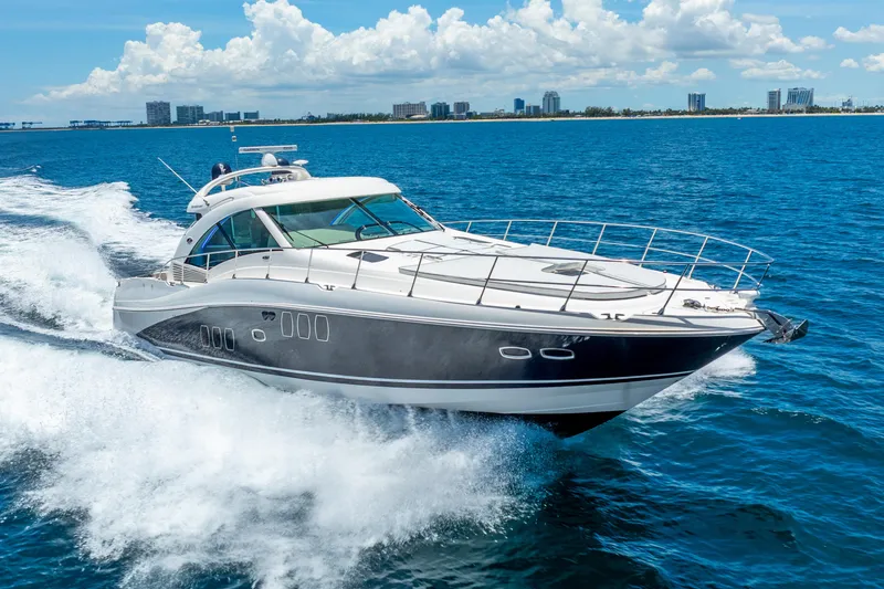 Slide: The Image of 2008 Sea Ray 60 Sundancer yacht cruising on open water under a clear sky. - 2