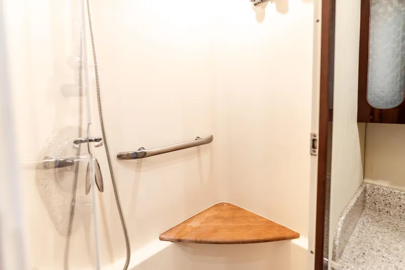 Slide: The Image of Shower area in 2008 Sea Ray 60 Sundancer yacht with wooden seat and grab bar. - 24