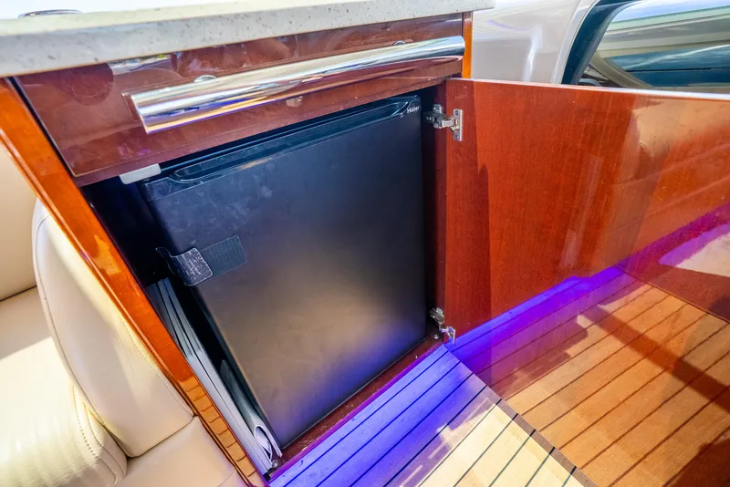Slide: The Image of Luxury yacht Sea Ray 60 Sundancer 2008 interior with mini fridge and wooden cabinetry. - 34