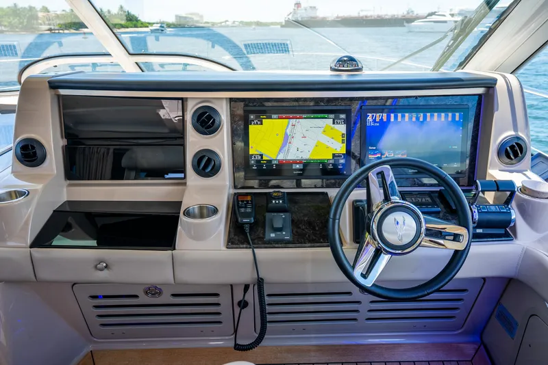 Slide: The Image of Helm of 2008 Sea Ray 60 Sundancer with navigation screens and steering wheel. - 35