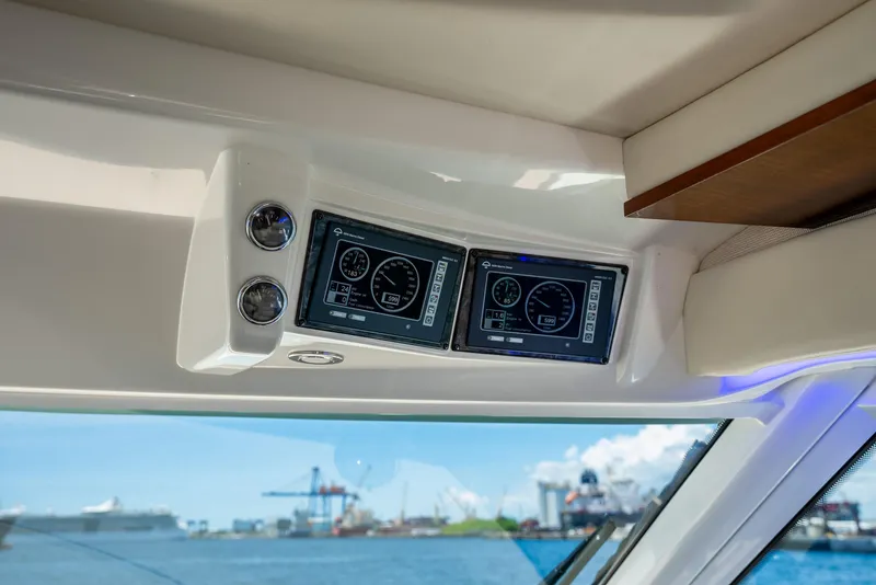 Slide: The Image of Control panel of 2008 Sea Ray 60 Sundancer yacht with harbor view in background. - 41