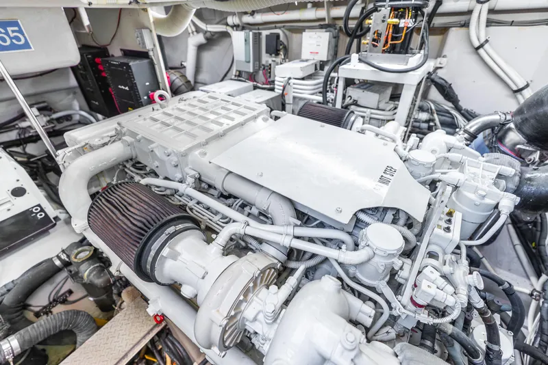 Slide: The Image of Engine room of 2008 Sea Ray 60 Sundancer yacht, showcasing complex machinery and components. - 48