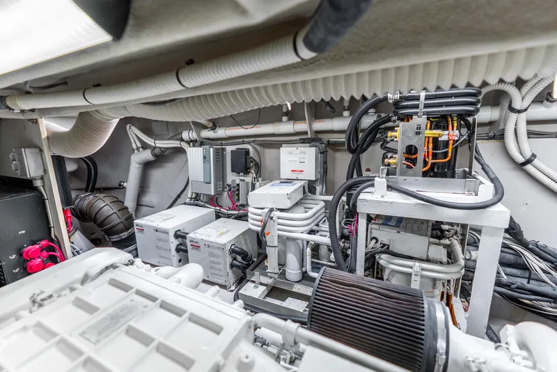 Slide: The Image of Engine room of 2008 Sea Ray 60 Sundancer yacht, showcasing mechanical components and wiring. - 49