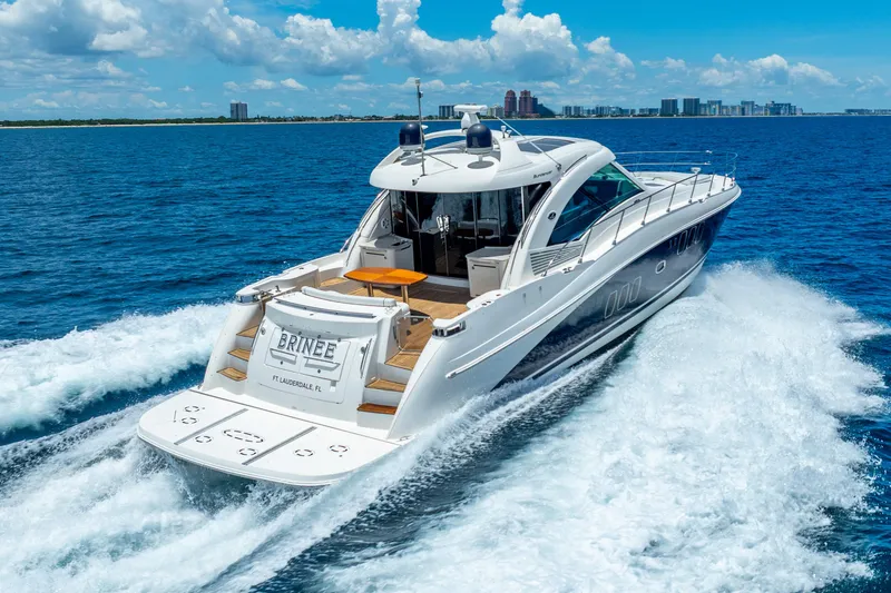 Slide: The Image of 2008 Sea Ray 60 Sundancer yacht cruising on blue ocean near city skyline. - 5