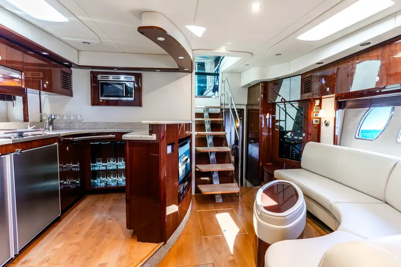 Slide: The Image of Luxurious interior of 2008 Sea Ray 60 Sundancer yacht with modern kitchen and seating area. - 9