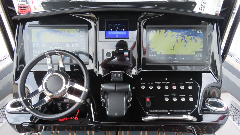 Slide: The Image of 2023 Sunsation 32 CCX dashboard with dual navigation screens and modern controls. - 16