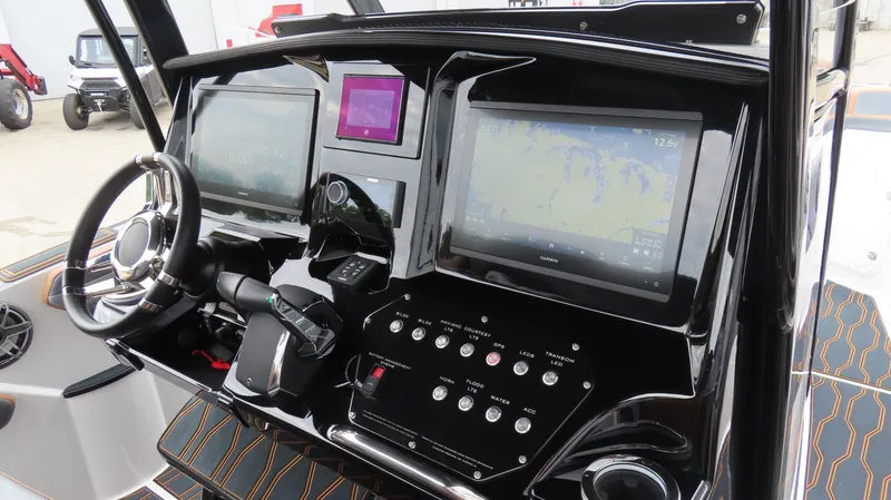 Slide: The Image of 2023 Sunsation 32 CCX boat dashboard with dual screens and control panel. - 17