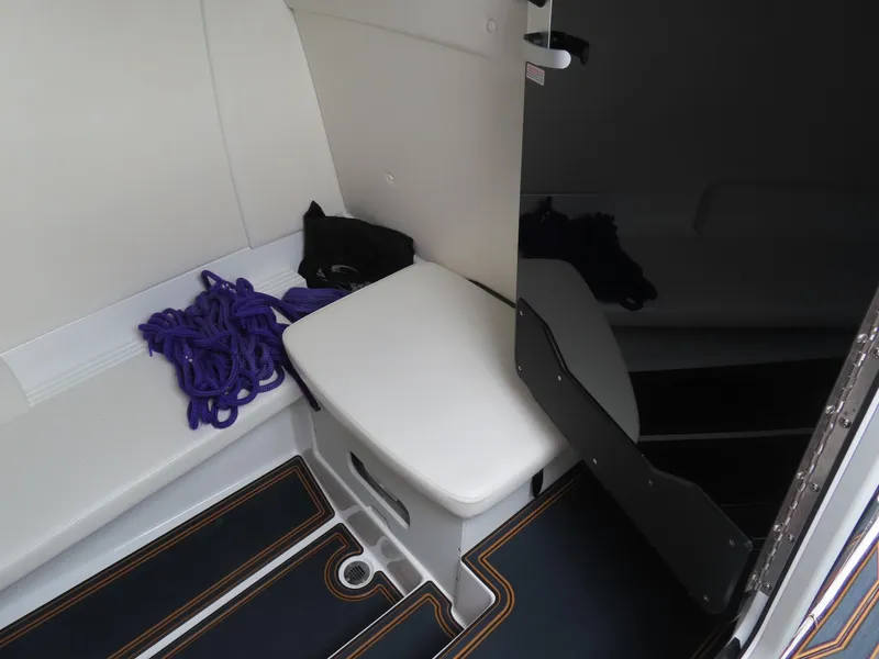 Slide: The Image of 2023 Sunsation 32 CCX interior with seating, purple rope, and storage compartment. - 26