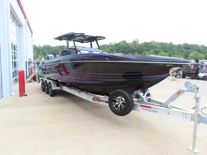 Slide: The Image of 2023 Sunsation 32 CCX boat on trailer, sleek design, parked outdoors. - 3